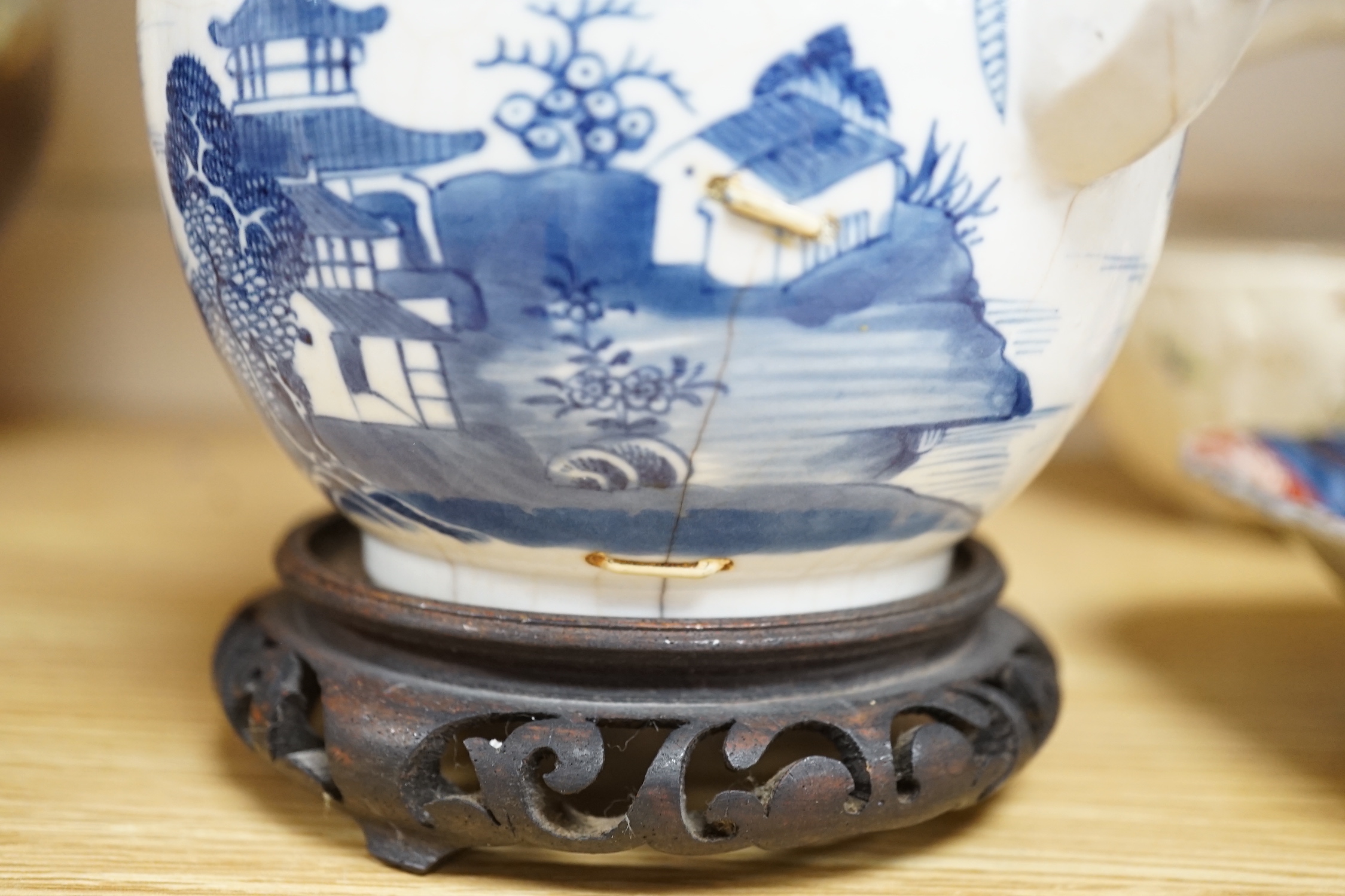 An 18th century Chinese blue and white teapot and cover, with hardwood stand, 19cm total height